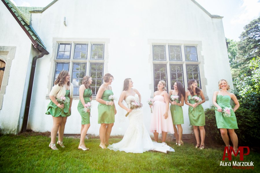 Bride wears sweetheart wedding gown and bridesmaids wear green cocktail length dresses. © Aura Marzouk Photography