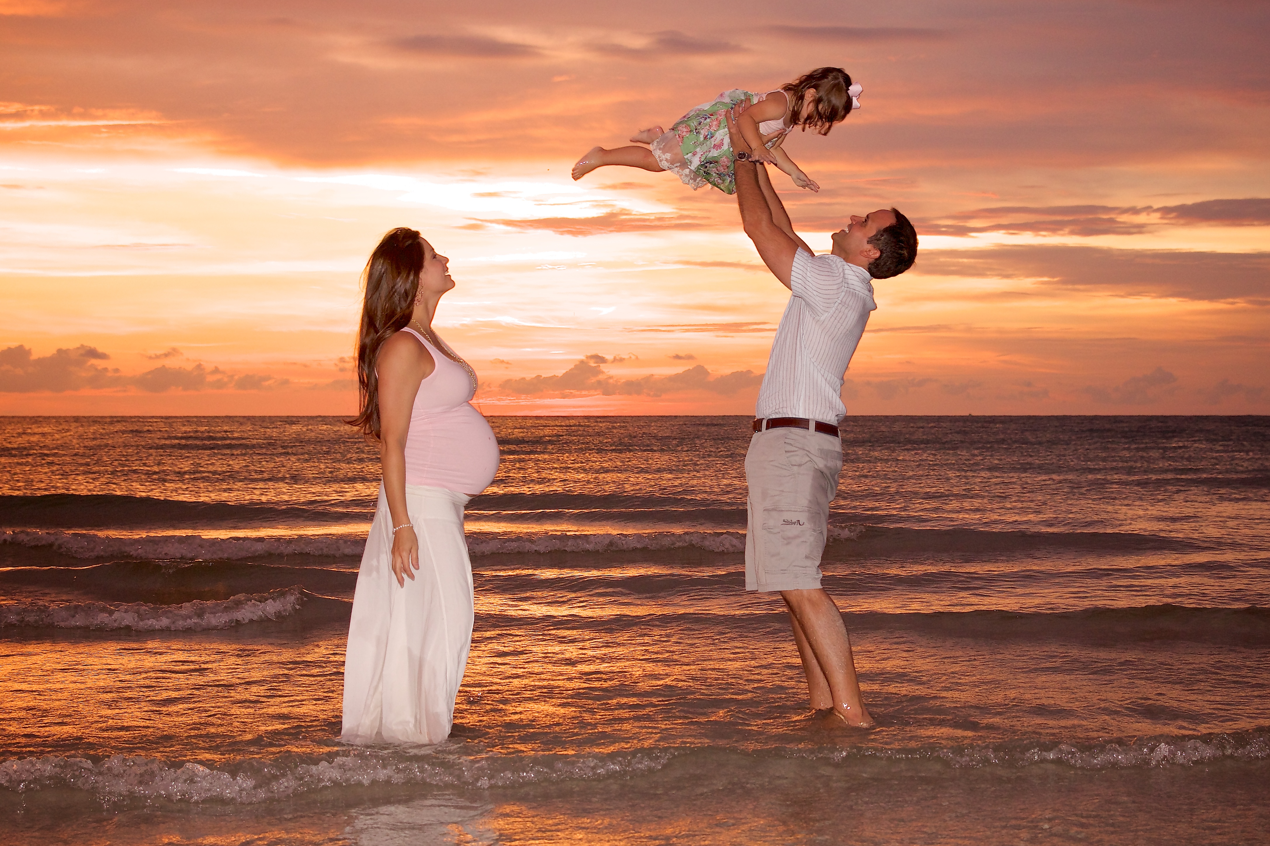 Clearwater Beach maternity photos family at Sand Key playing in water