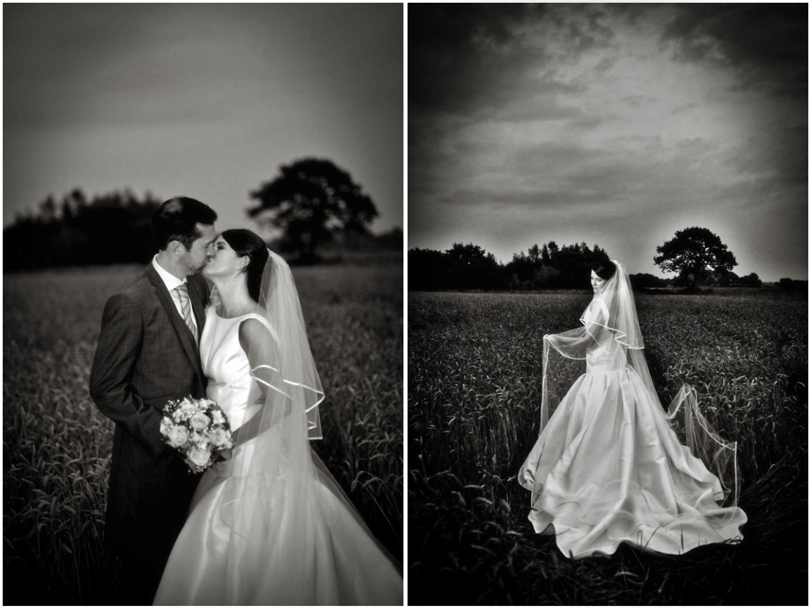 Black and white photograph of wedding couple in field