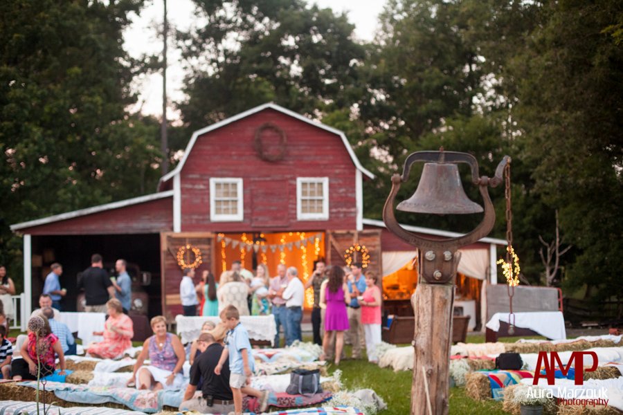 Red barn and antique bell on this authentic barn venue in Seagrove. © Aura Marzouk Photography