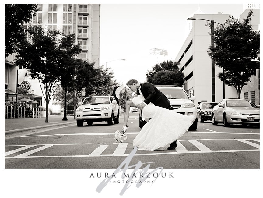 Jessica and Chad kiss and dip on the streets of Charlotte, North Carolina. © Aura Marzouk Photography, Greensboro Wedding Photographer