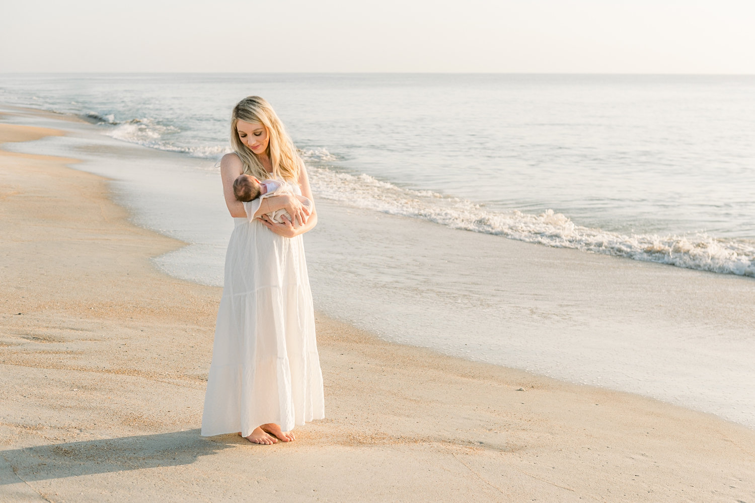 beautiful blonde mom walking on beach with newborn son, Ryaphotos