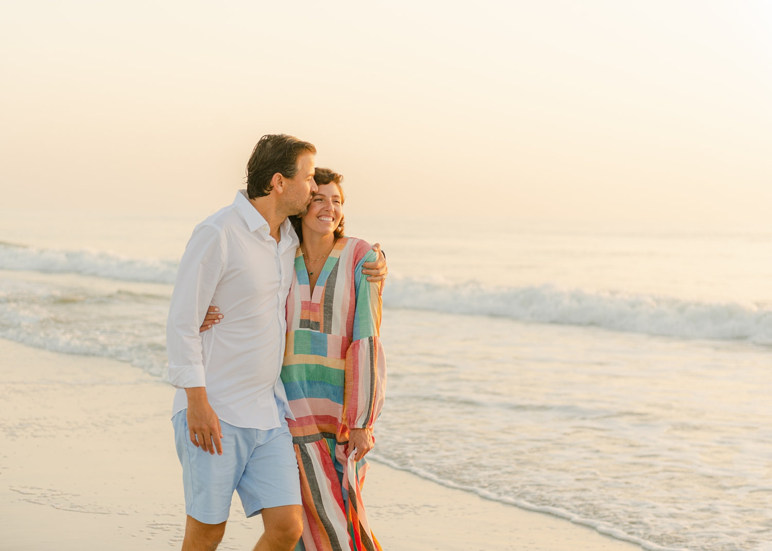 cancer survivor and her husband walking along the Florida coast, Ryaphotos