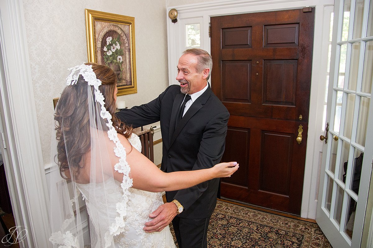 happy first glance moment with bride and father