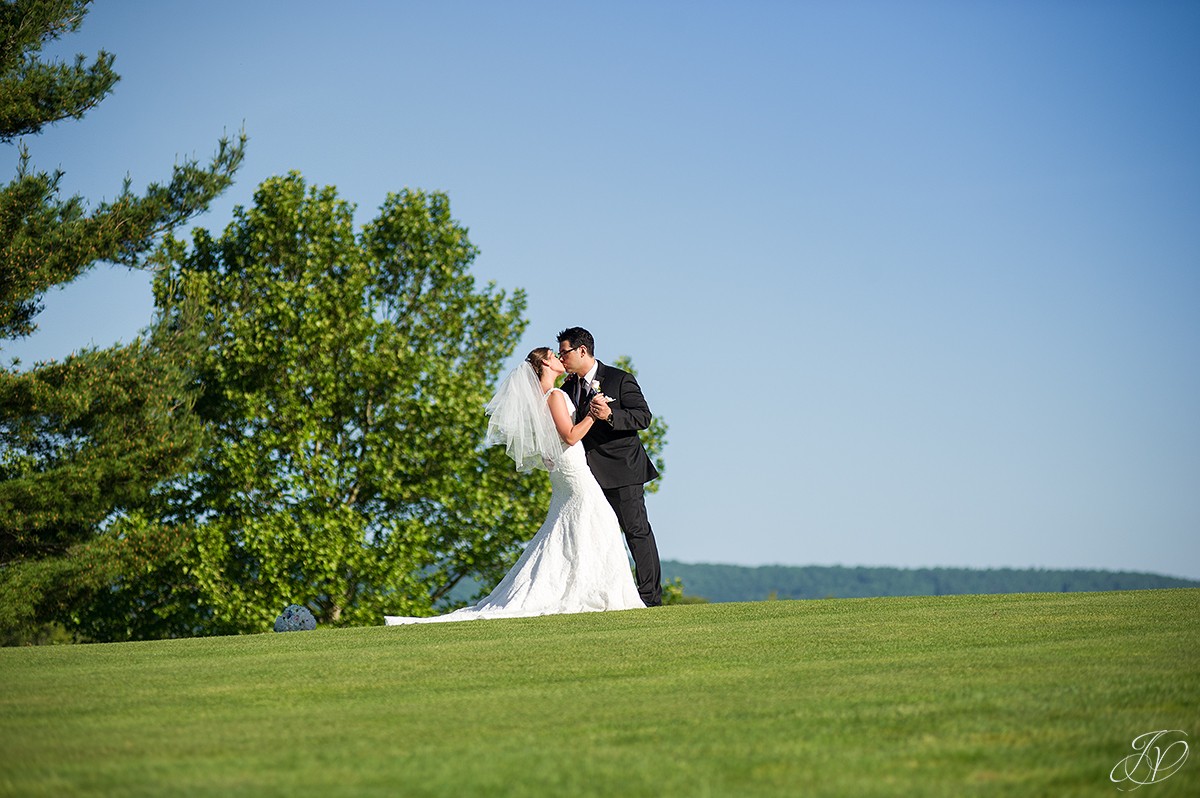 bride and groom kissing golf course photo