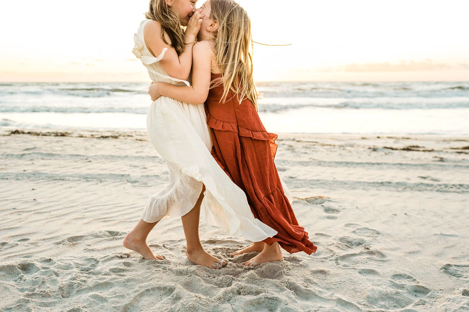 little sisters hugging on a beach, Joyfolie dresses for girls, The Ritz-Carlton, Amelia Island