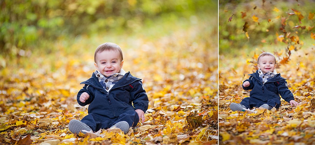 adorable one year old playing in leaves