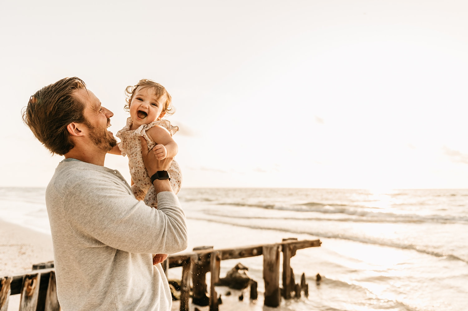 dad holding up laughing baby girl, daddy daughter photos, Rya Duncklee