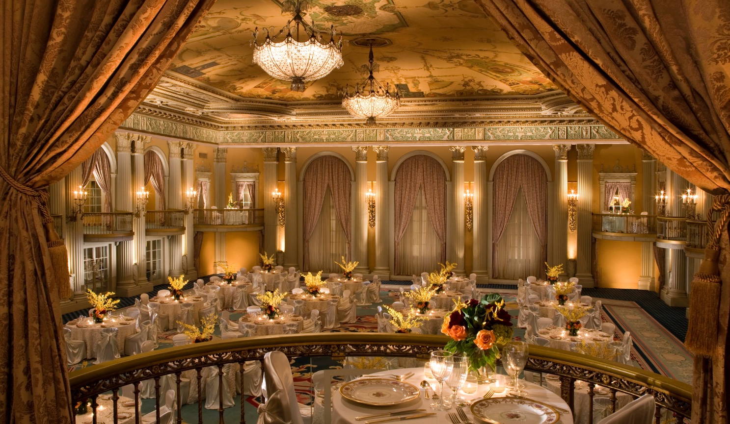 A Beautiful Ballroom with Tiffany Chandeliers and Beautifully lit tables for a Ballroom Dance.
