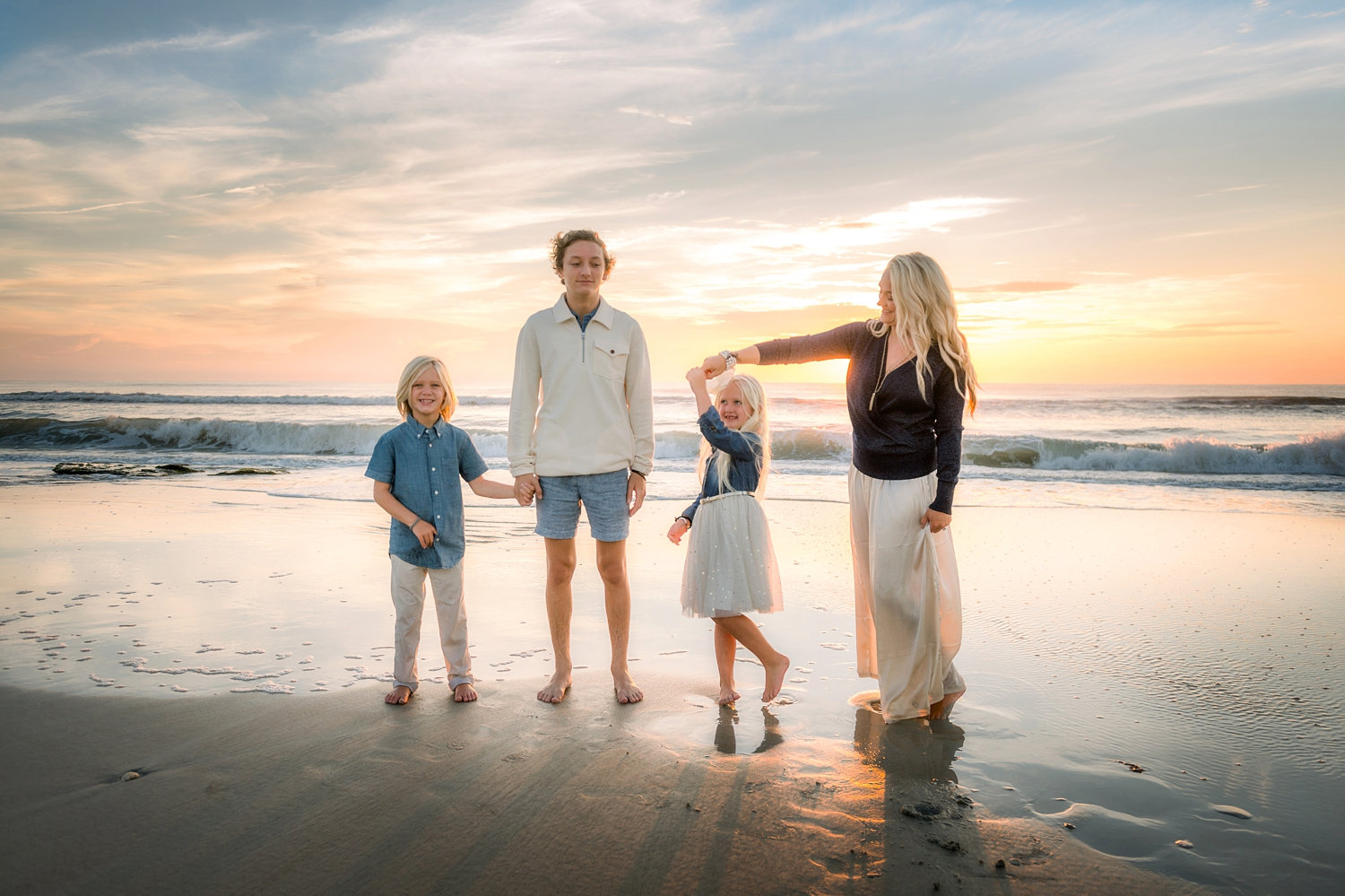 mom and three children twirling in the sand, Saint Augustine Beach, Florida