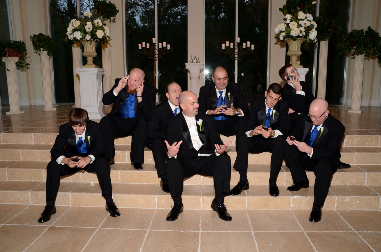 Groom and groomsmen sitting on steps