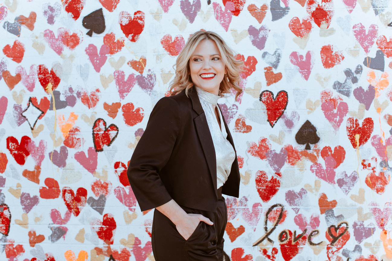 Styled portrait of Janel downtwon and with art mural of hearts and natural light, portrait picture taken by Adam Trujillo, a Las Vegas portrait photographer.