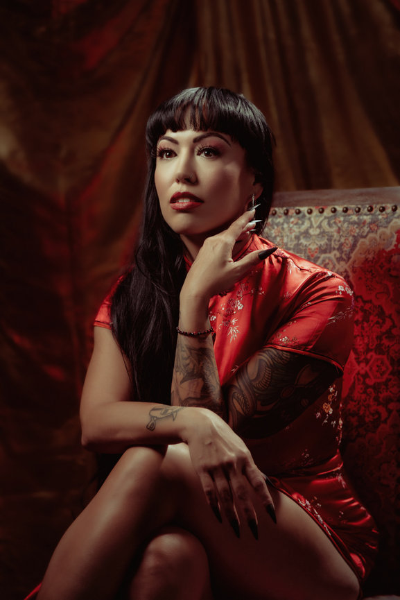 Professional portrait of woman in authentic chinese dress and gold and yellow backdrop, taken in a photo studio with Adam Trujillo, a Las Vegas portrait photographer.