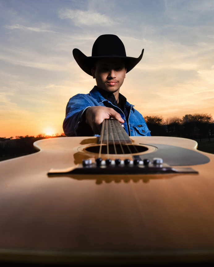 Senior guy portrait with guitar at sunset