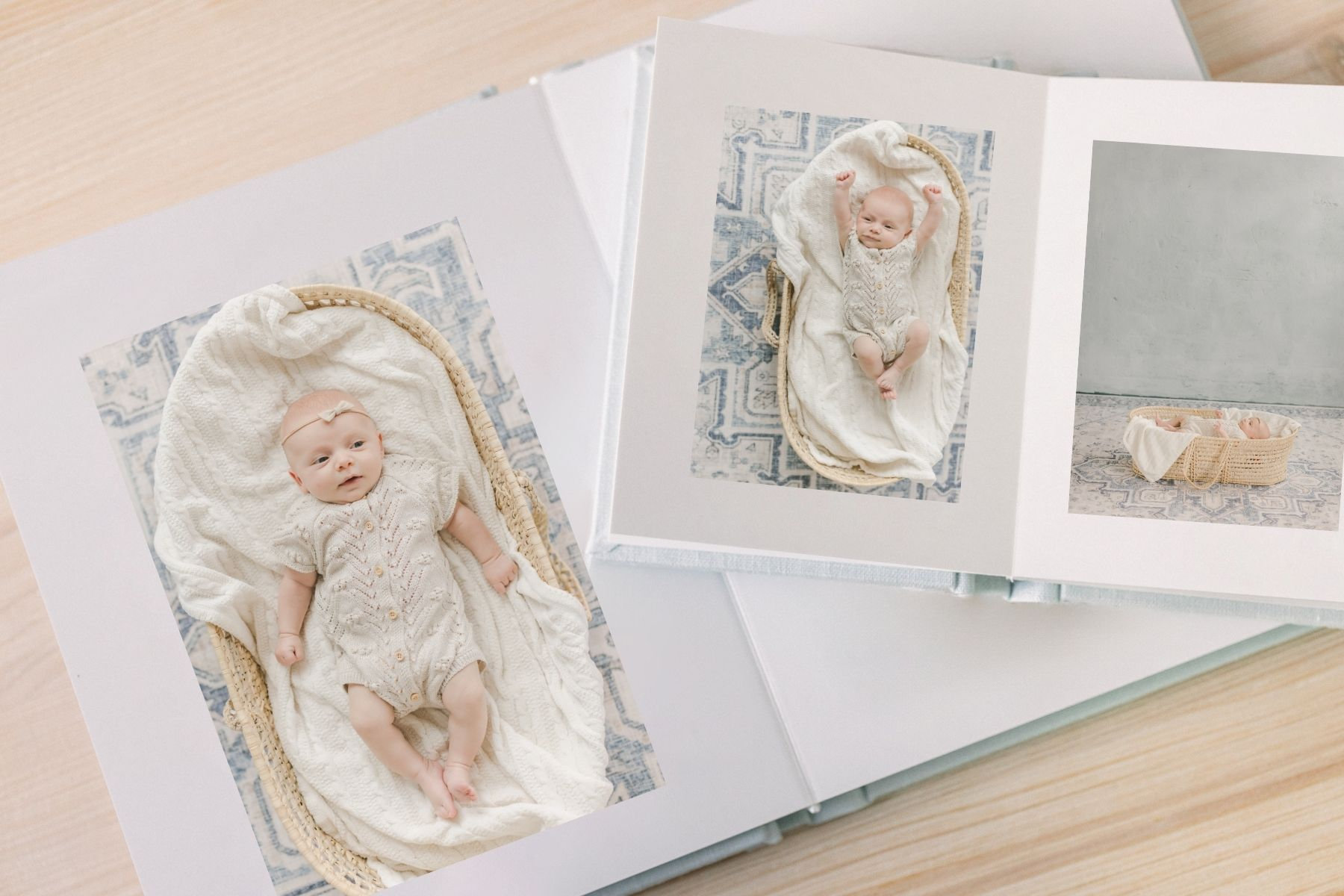 Baby photo album featuring a newborn in a cozy blanket and two artistic images of the baby.