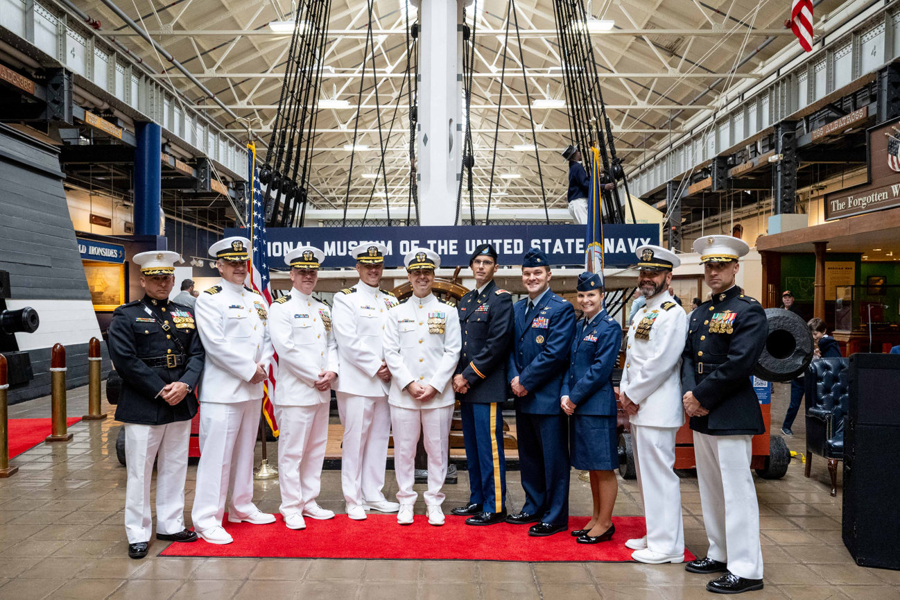 Naval Officer posing with Army, Air Force and Marine Corps participants at his retirement ceremony