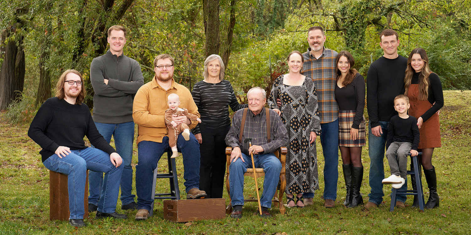 Extended family portrait outdoors during fall with multiple generations, photographed by a Sherman TX family photographer
