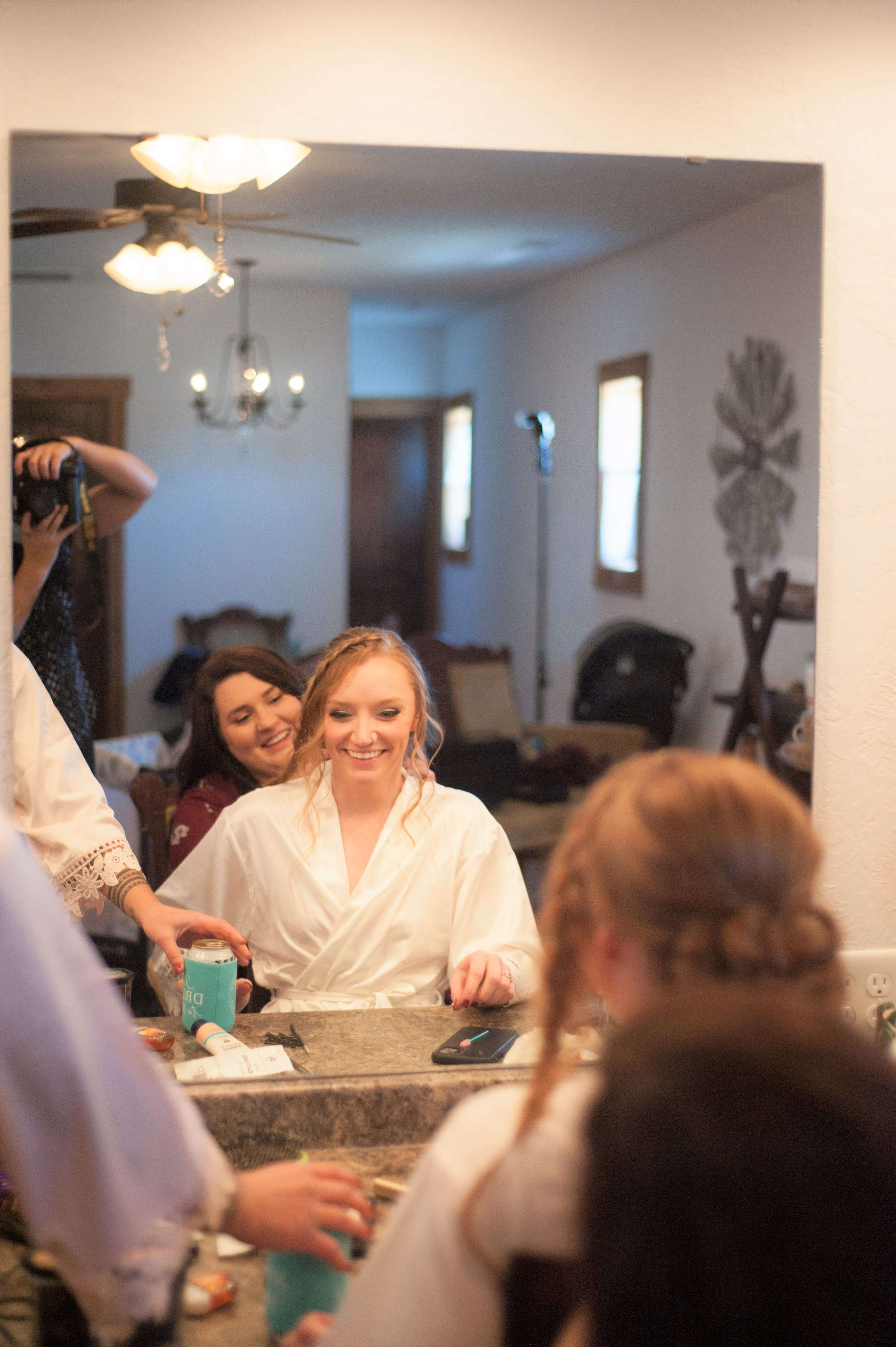 Bride getting ready for her wedding with her bridesmaids.