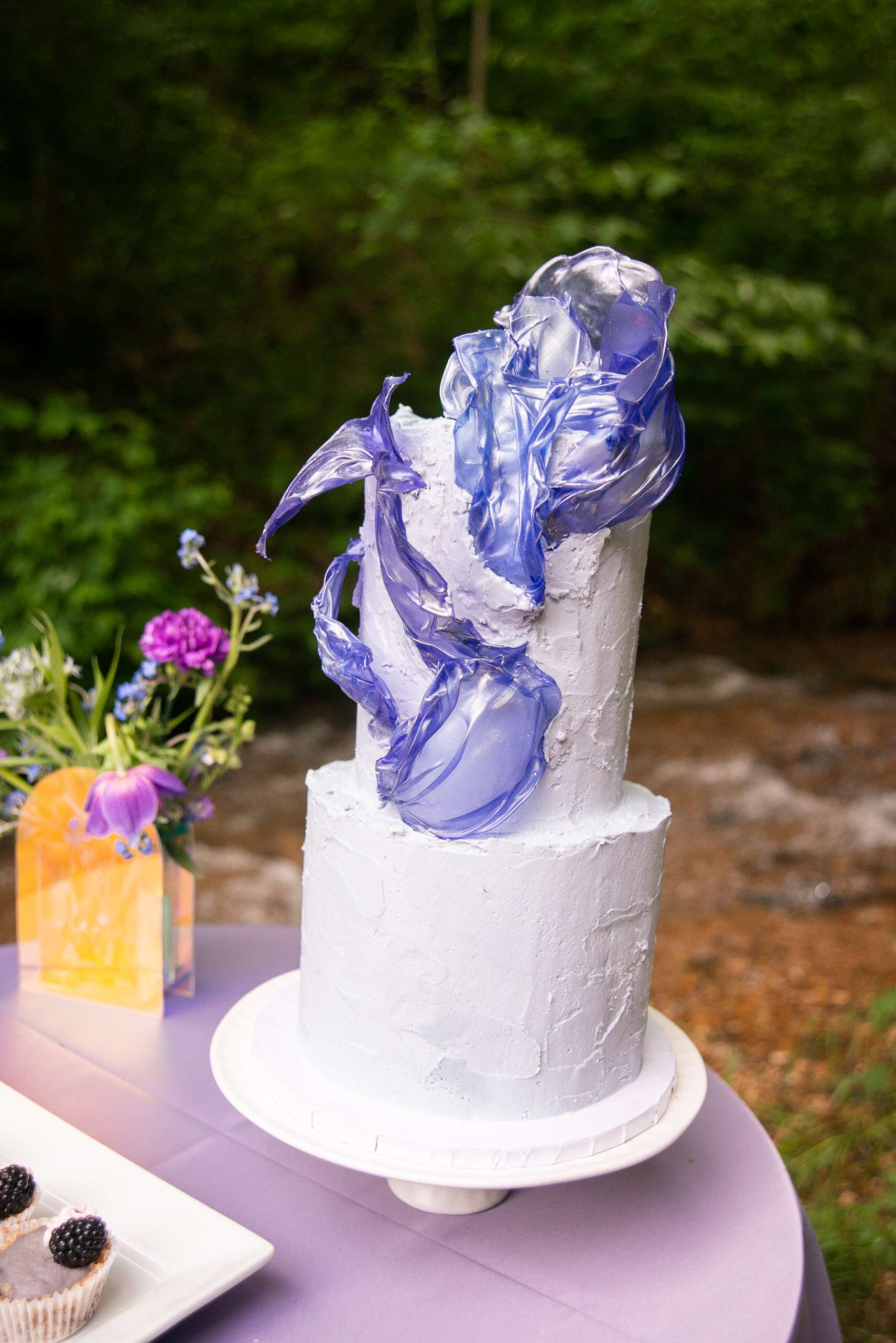 Cake and flowers on a reception table at Enchanted Hills