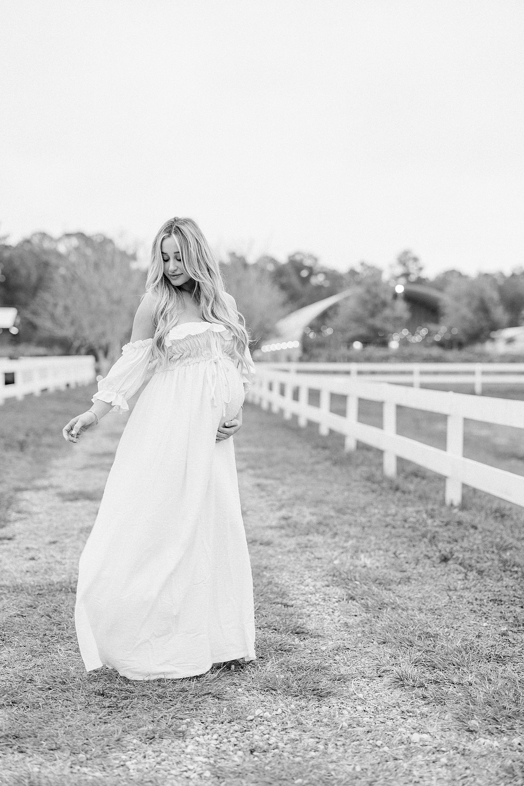 black and white maternity portrait of women in white maxi dress at Congaree and Penn farm Jacksonville Florida