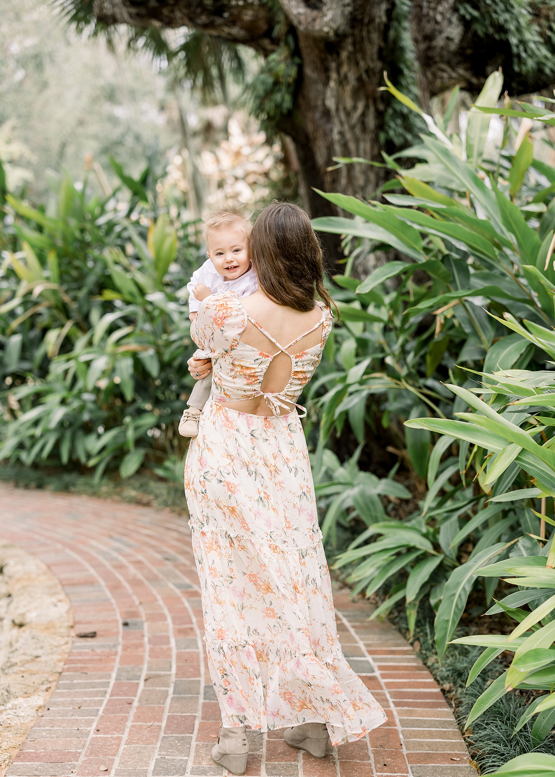 woman in floral maxi dress walking in the gardens at Washington Oaks State Park in the springtime