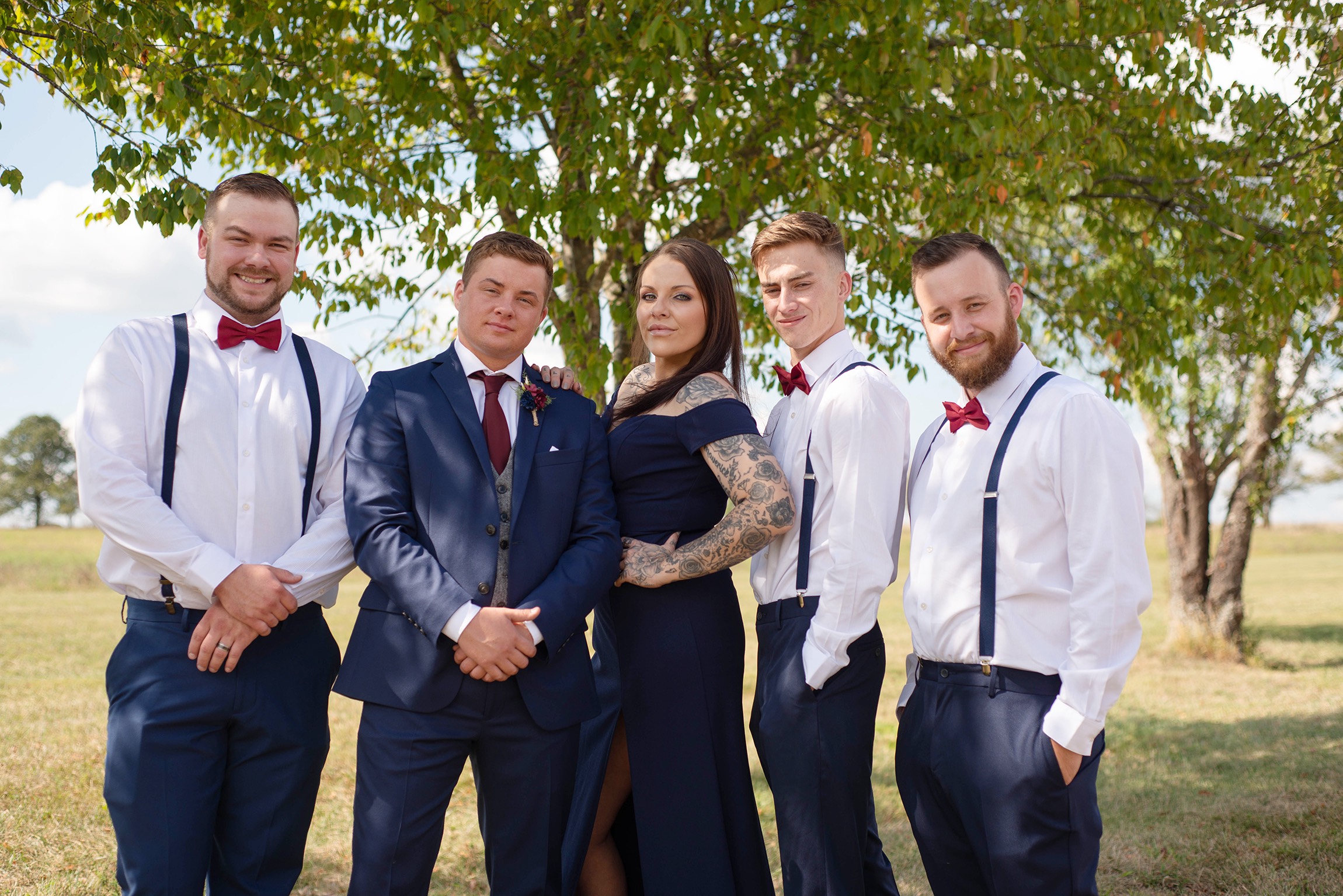 Groom in suit and tie with groomsmen and best woman.