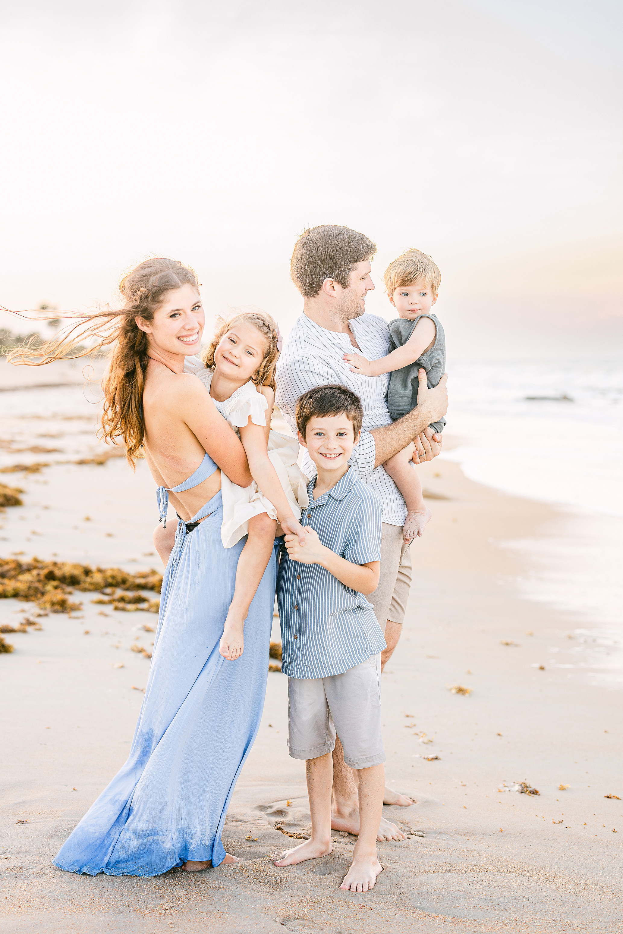 light and airy family beach portrait at sunset