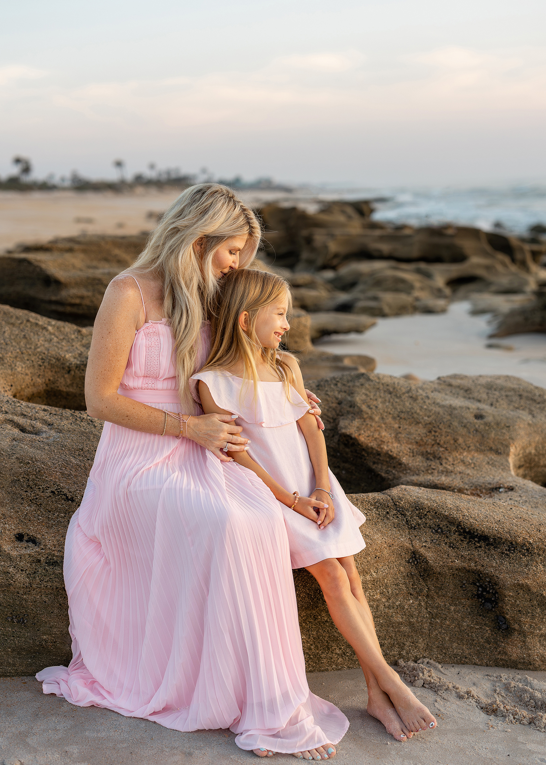 Sunrise beach session in Saint Augustine with pastel skies and pink dress