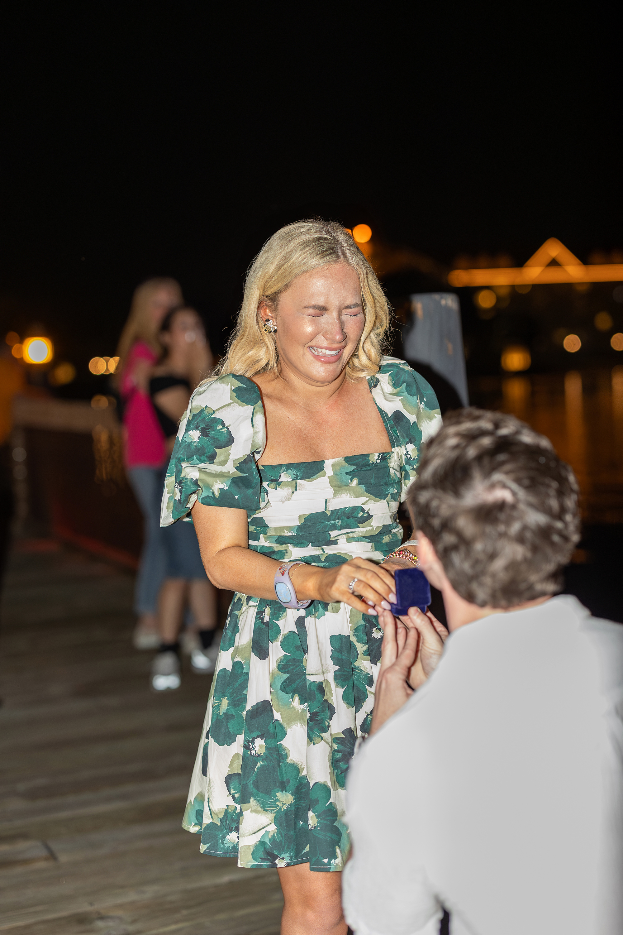 A man kneels down on the dock at Disney's Polynesian Resort to propose.