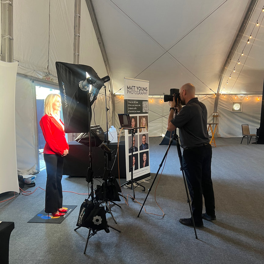 Attendees getting professional LinkedIn headshots at trade show booth in Arizona