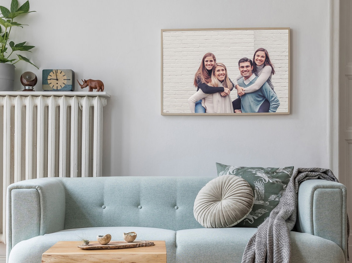young adult siblings framed on the wall above a couch