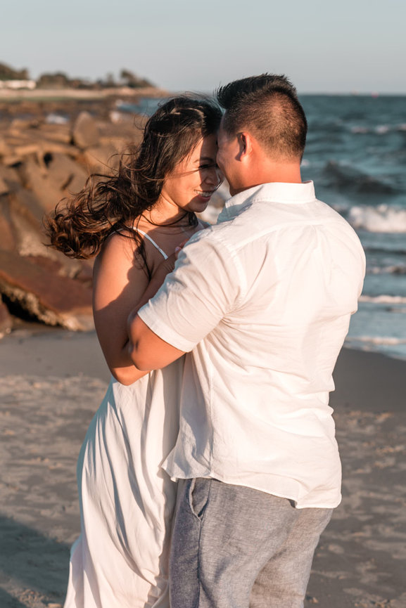 A timeless moment on the secluded limestone cliffs of Warwick Long Bay, highlighting the contrast between the jagged shoreline and the translucent azure waters of the Atlantic.