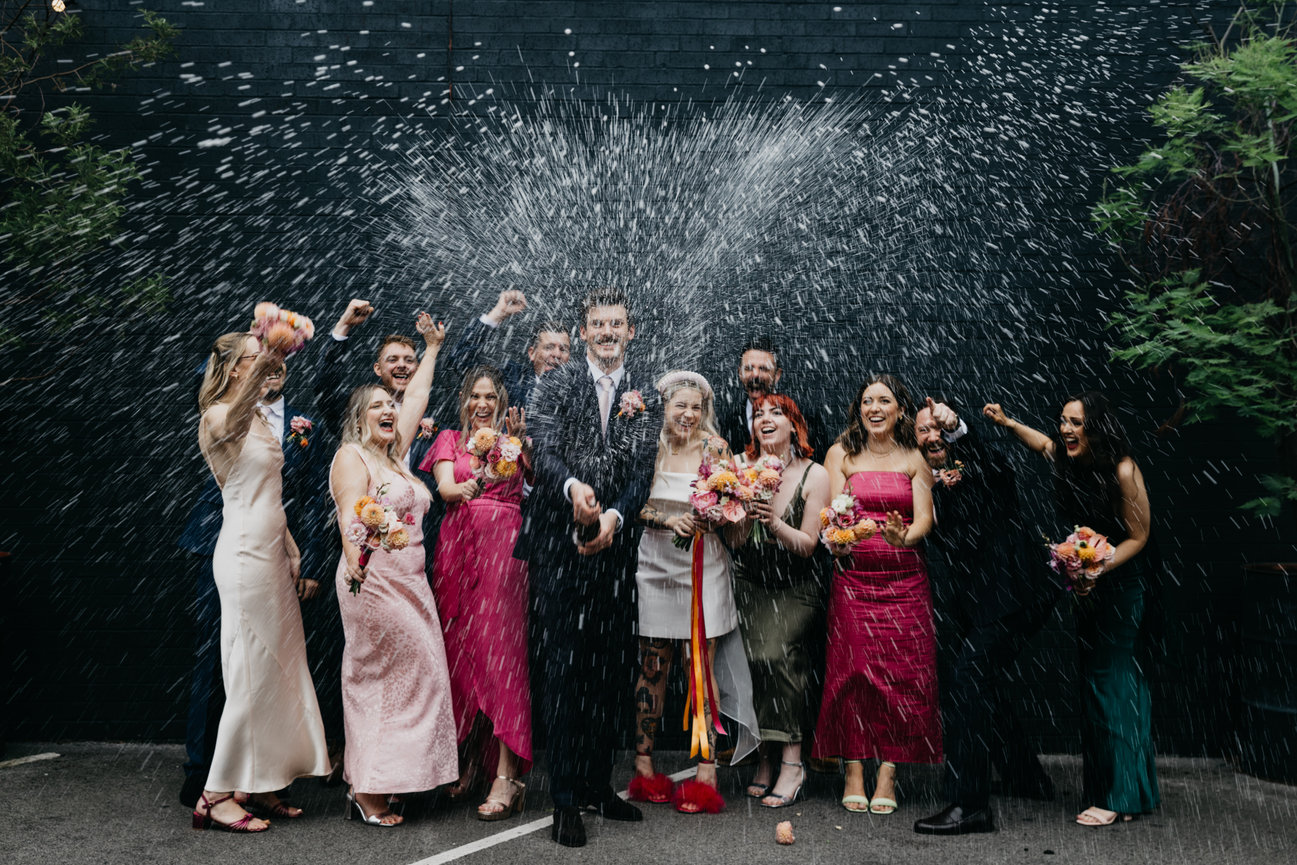 Editorial wedding photography bridal party champagne spray celebration at fivefourstudios, Manchester.