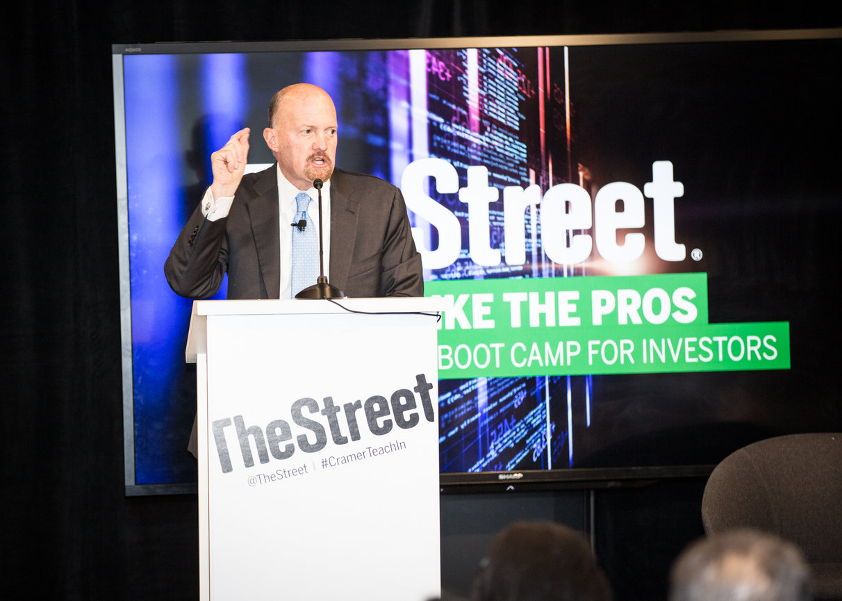 Man speaking at a podium with TheStreet and Boot Camp for Investors on screen in background.