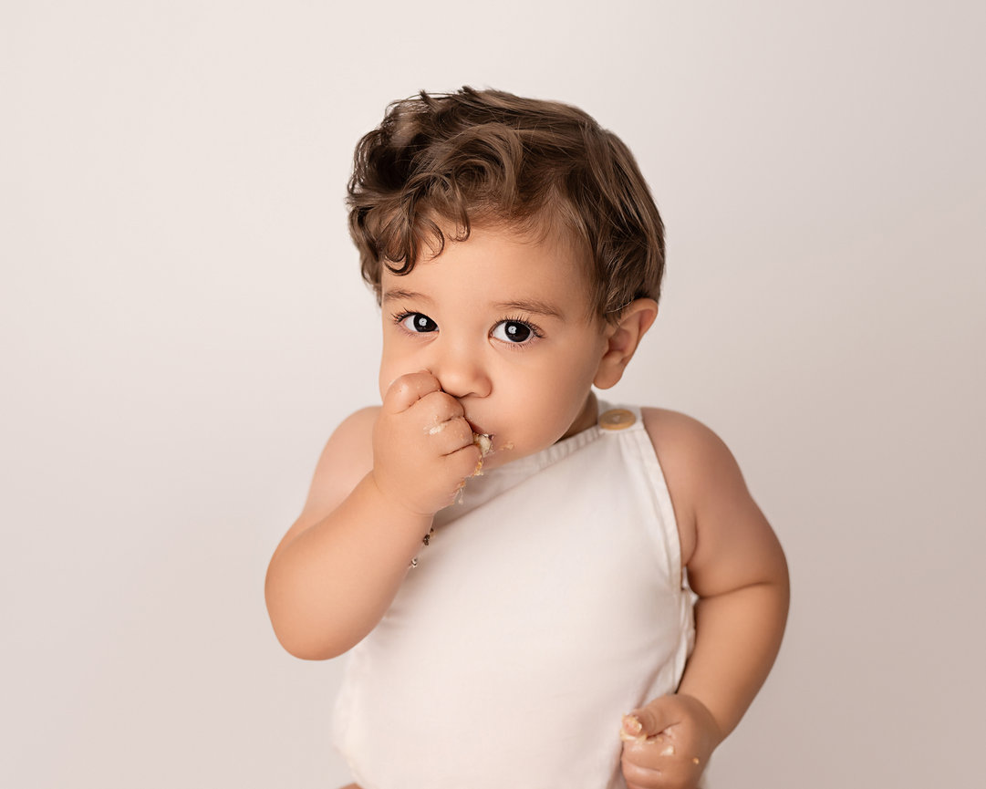 Baby’s reaction to tasting cake for the first time, photographed naturally in Rumson photography studio
