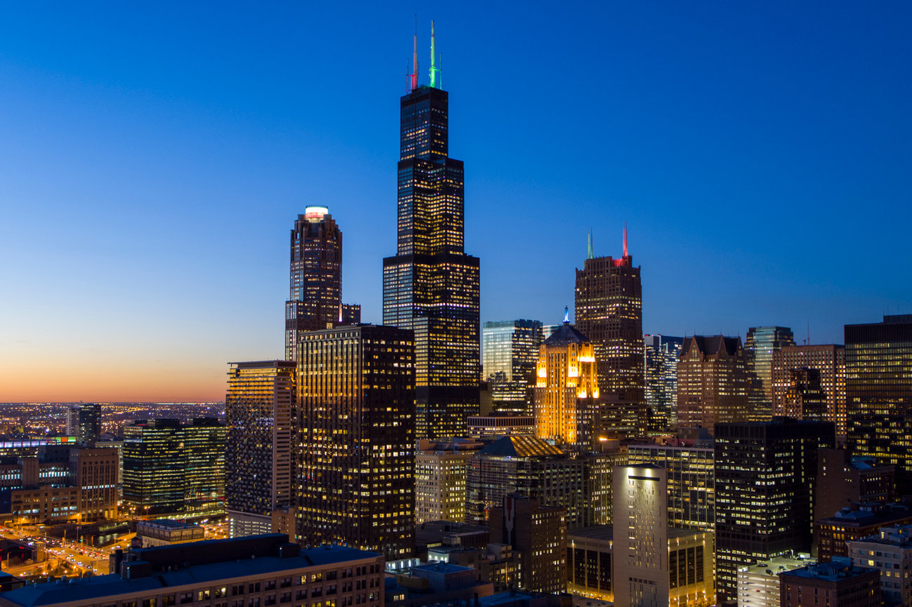City skyline lights illuminating at dusk