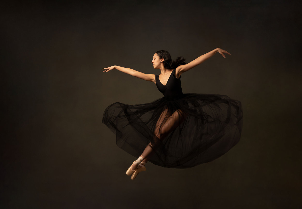 Ballet dancer posing in flowing black dress during fine art portrait session by Eye Spy Photography in Hudson Valley NY