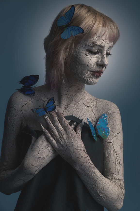 Fine art portrait with butterflies on shoulders and textured body paint, DFW editorial photographer