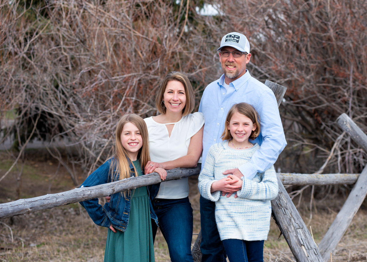 family of four enjoying a family photo session at Glen Lake Rotary Park in Bozeman, Montana