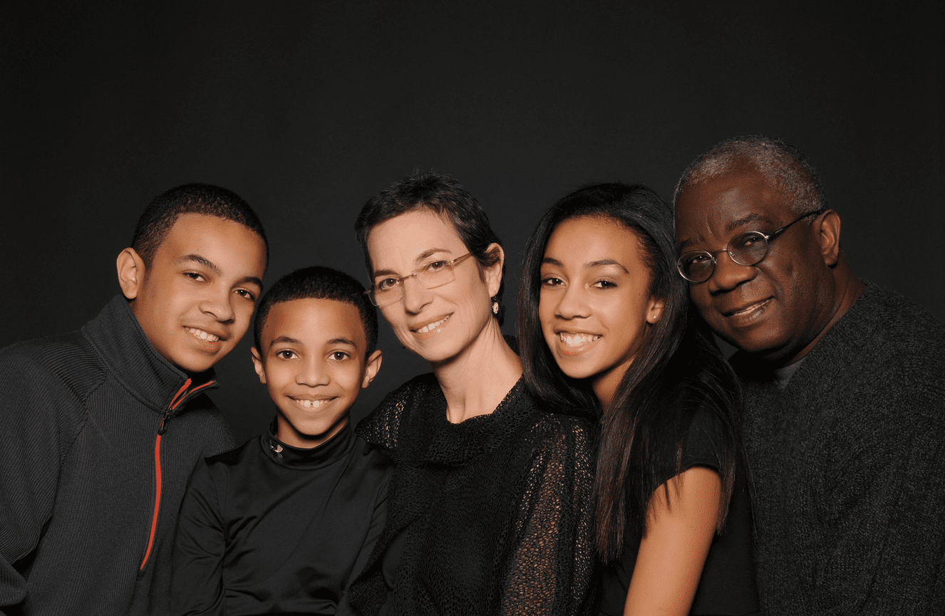 A smiling multi-racial family at Kliks Photography in Cedar Rapids.