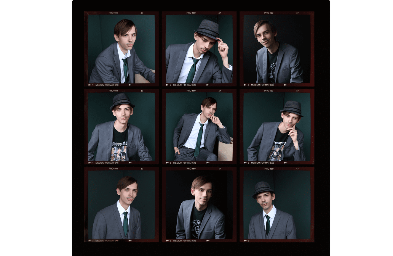 A show choir student in a suit jacket, graphic t-shirt, and fedora hat.