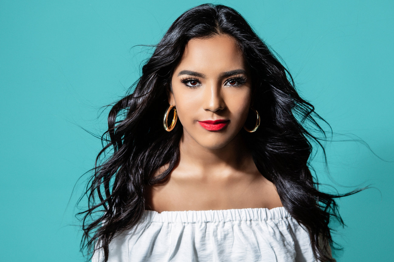 Photo session in the studio on a blue background of a graduating senior