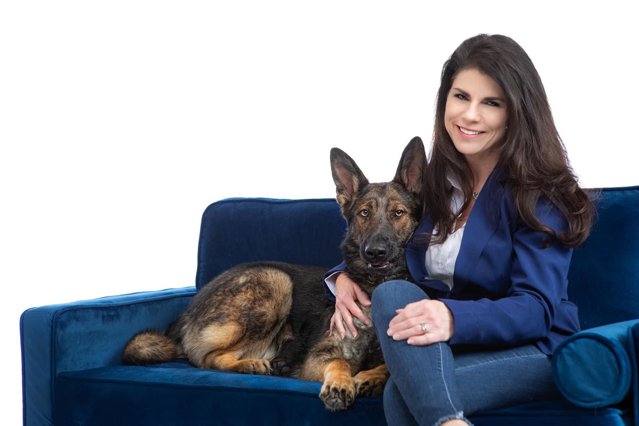 Realestate professional with her dog in studio for a portrait.