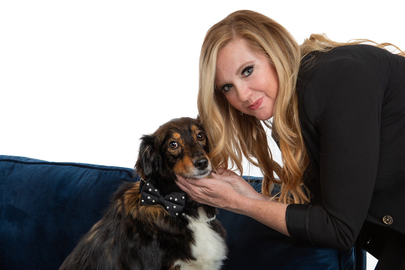 An image of a woman with her dog in the studio.
