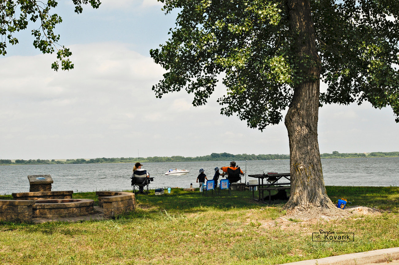 A young family enjoying a picnic outing along the Calamus Reservoir, Burwell, NE.